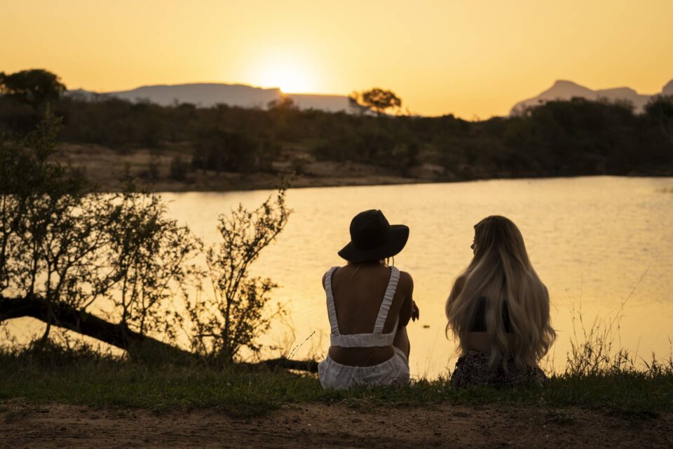 photo of two women enjoying a sunset at Waterbuck Game Lodge